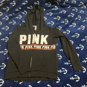 A small black pink hoodie that has been worn twice.